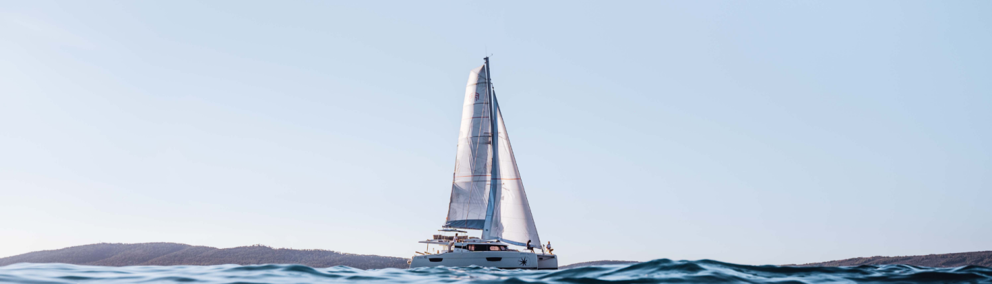 A distant view of a Fountaine Pajot sailing catamaran yacht
