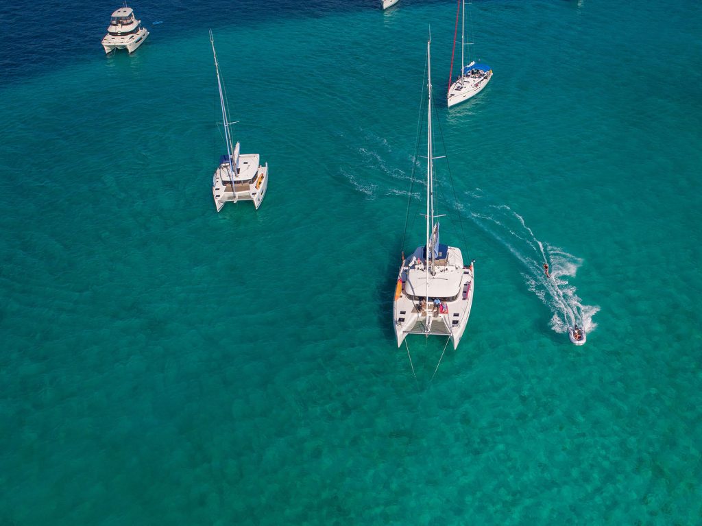Several sailing catamarans cruising in Croatia